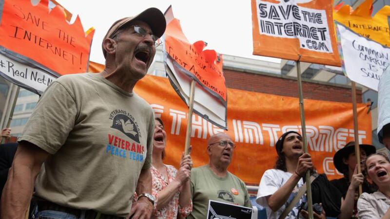 Activists protest outside the US Federal Communications Commission as the body debates reforming net neutrality. Photograph: Alex Wong/Getty Images