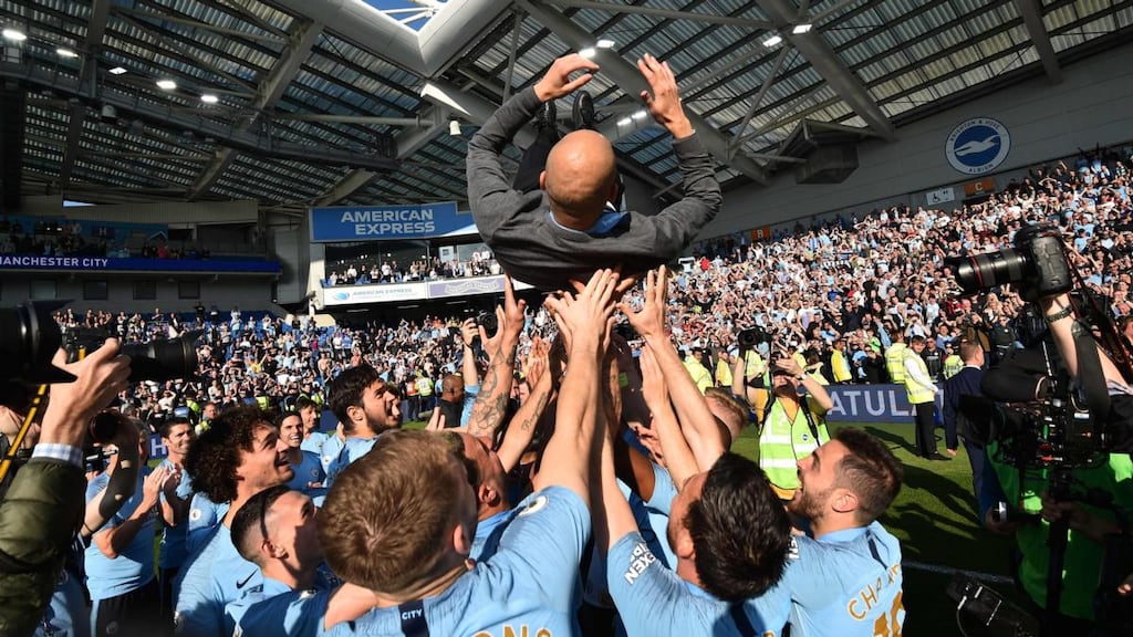 Manchester City  manager Pep Guardiola is thrown into the air by his players as they celebrate after their 4-1 victory against Brighton  to become  Premier League champions for a second consecutive year. Photograph: Glyn Kirk/AFP