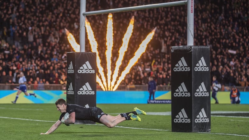 Beauden Barrett of New Zealand dives under the posts to score one of his four tries against Australia. Photograph: EPA