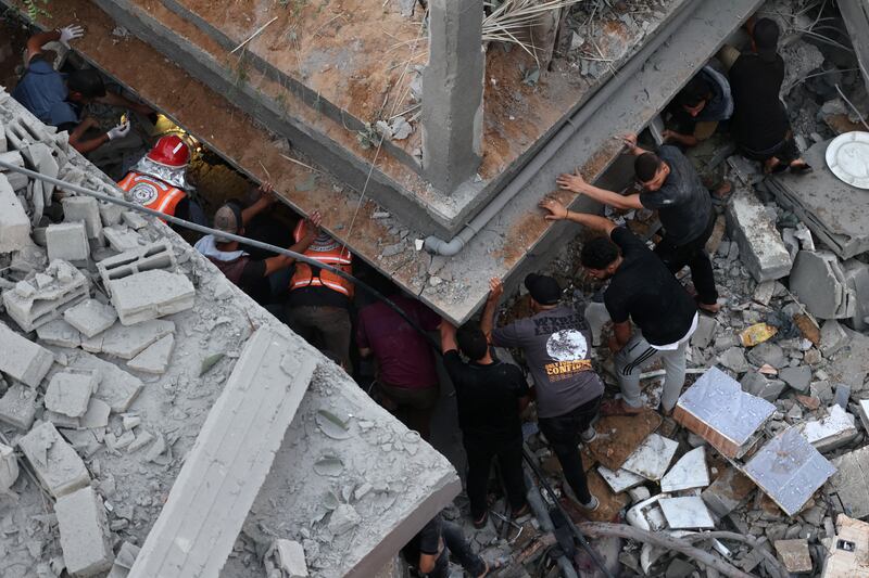 Palestinians search for survivors at the site of an Israeli strike on the Al-Daraj neighbourhood in Gaza City. Photograph: Omar Al-Qattaa /AFP via Getty Images