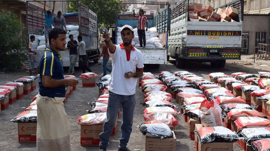 Yemenis unload food parcels provided by the Red Crescent in the southern port city of Aden. Yemenis’ ability to buy food has deteriorated. Photograph: Saleh al-Obeidi/AFP/Getty Images.