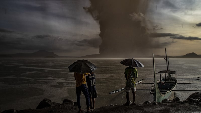 Residents look on as Taal Volcano erupts in Talisay, Batangas province, Philippines Photograph: Ezra Acayan/Getty Images