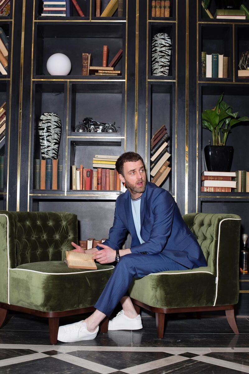 Blue suit jacket €280, trousers €170, Richard James. Light blue Fred Perry T-shirt €50, Kurt Geiger trainers €110.