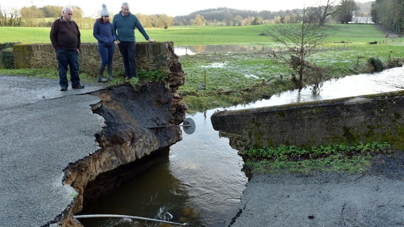 Locals Joe Kehoe, Sue Doyle, and Vincent Finn on the damaged Wilton Bridge in Bree Co Wexford after the floods on Christmas day. Photograph: Maura Hickey