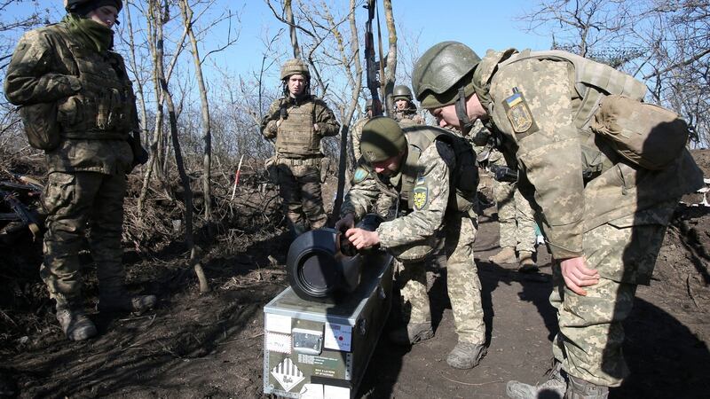 Ukrainian military forces in the Donetsk region examine a Swedish-British portable anti-tank guided missile NLAW that was transferred to the units as part of Britain’s military-technical assistance. Photograph: Anatolii Stepanov/AFP via Getty