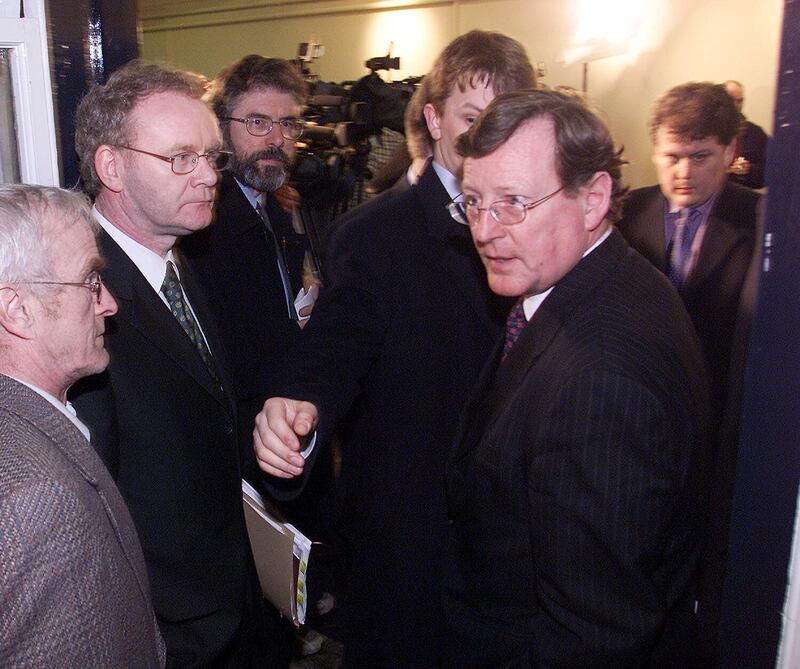 Ulster Unionist Leader David Trimble (right) is ushered past Sinn Féin leader Gerry Adams (third left) and chief negotiator Martin McGuinness (second left) after peace process talks broke up at Hillsborough Castle in March 2001. Photograph: Paul Faith/PA