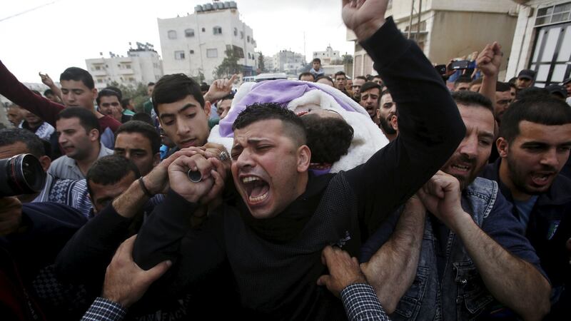 Mourners carry the body of Palestinian Mohammed Jabari, who stabbed an Israeli policeman before being shot dead, in the West Bank city of Hebron October Photograph: Mussa Qawasma/Reuters