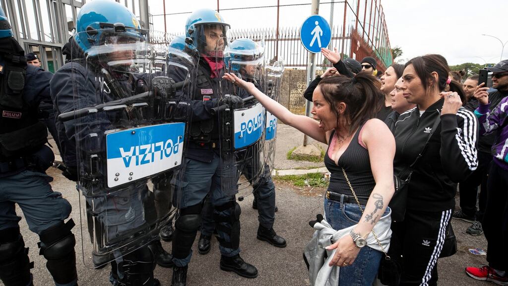 Relatives of inmates clash with police officers outside the Rebibbia prison, where a riot broke out, in Rome on Monday over new measures to contain the coronavirus outbreak. Photograph: Massimo Percossi/EPA