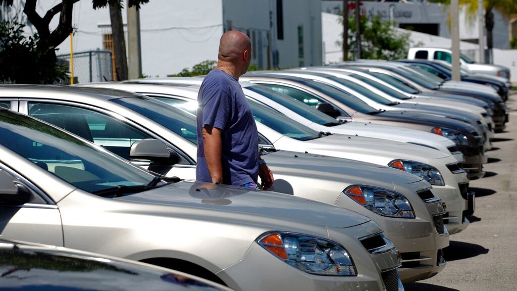 A man walks next to Chevrolet vehicles at a GM dealership in Miami, Florida: the Center for Automotive Research warns a tariff of 35 per cent could cut US car sales by 450,000 a year and cost 31,000 car industry-related jobs across the US. Photograph: Carlos Barria