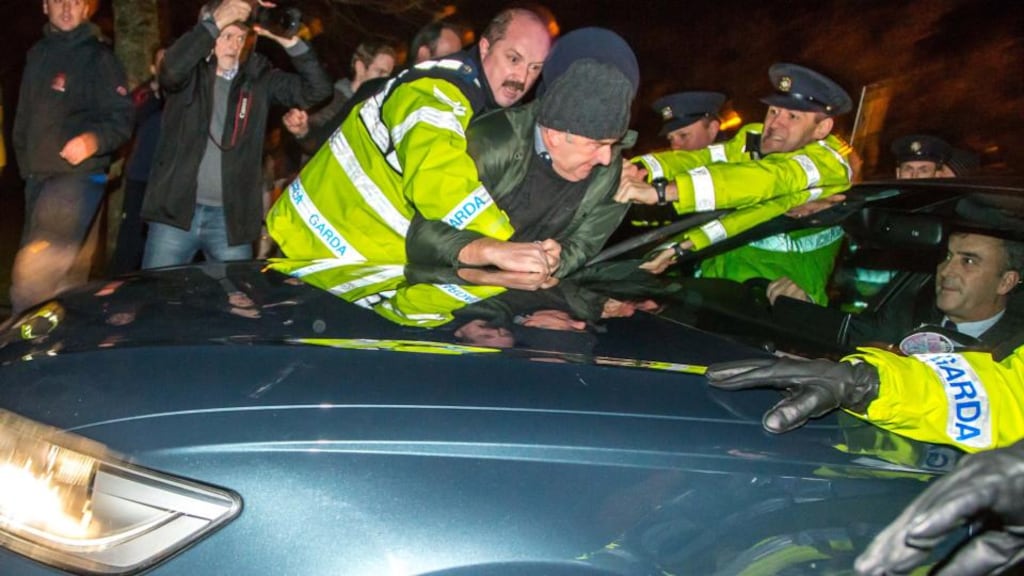 Gardaí attempt to remove a protestor from the bonnet of Enda Kenny’s car as it arrives at the Sligo Park Hotel. Photograph: James Connolly