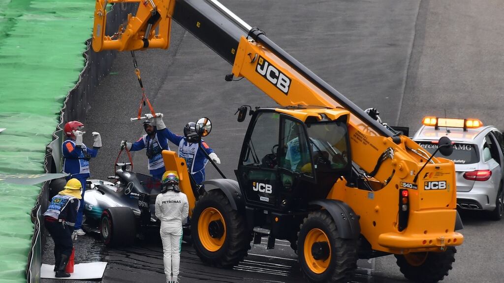 Mercedes driver Lewis Hamilton watches his car being removed from the racetrack after his crash during the Brazilian Formula One Grand Prix Q1 qualifying session at the Interlagos circuit in Sao Paulo. Photograph: Getty Images