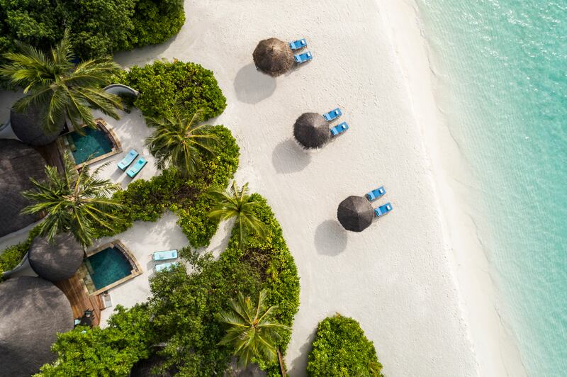 A private island escape of palm-lined pools and thatched-roof villas, Kuda Huraa Maldives blends laid-back charm with five-star polish