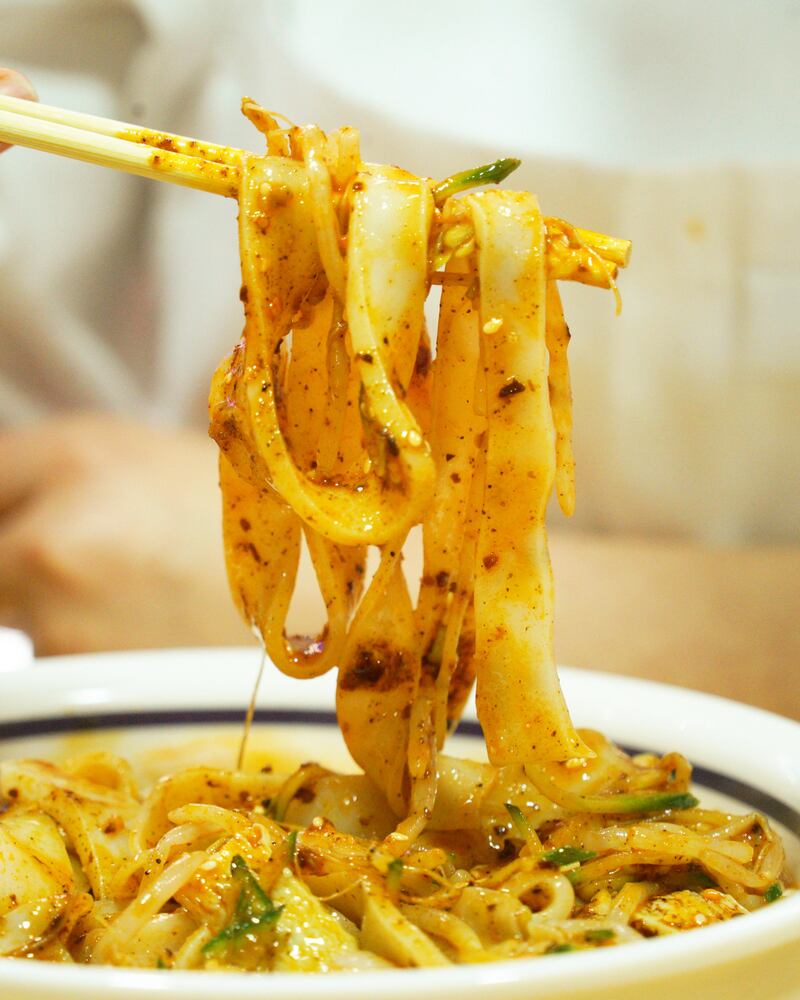Thick, ribbony flat wheat noodles are hand-pulled before being cooked to order at Biang Biang