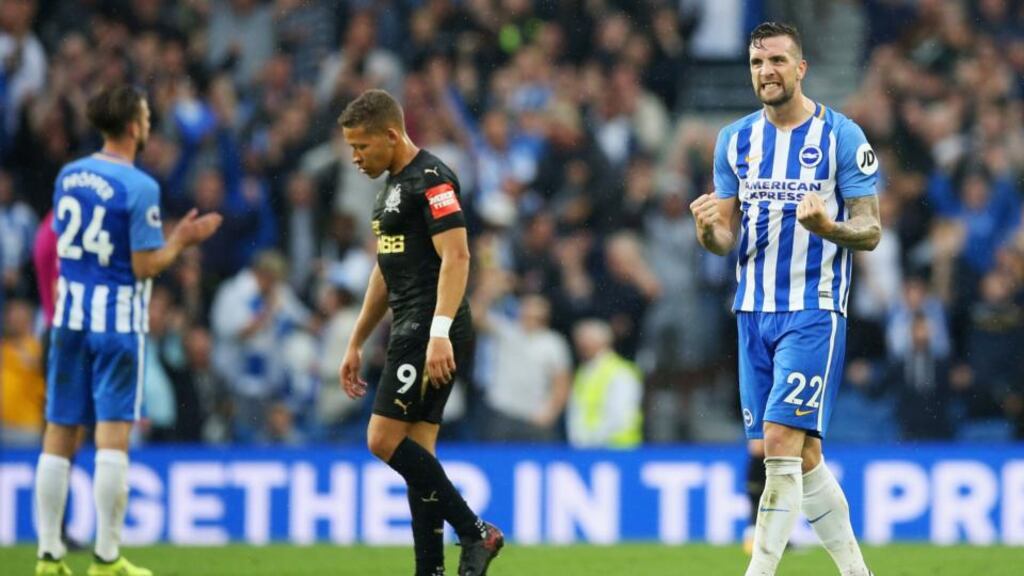 Brighton’s Shane Duffy  celebrates victory as Dwight Gayle of Newcastle United looks dejected after the Premier League match  at Amex Stadium. Photograph: Steve Bardens/Getty Images