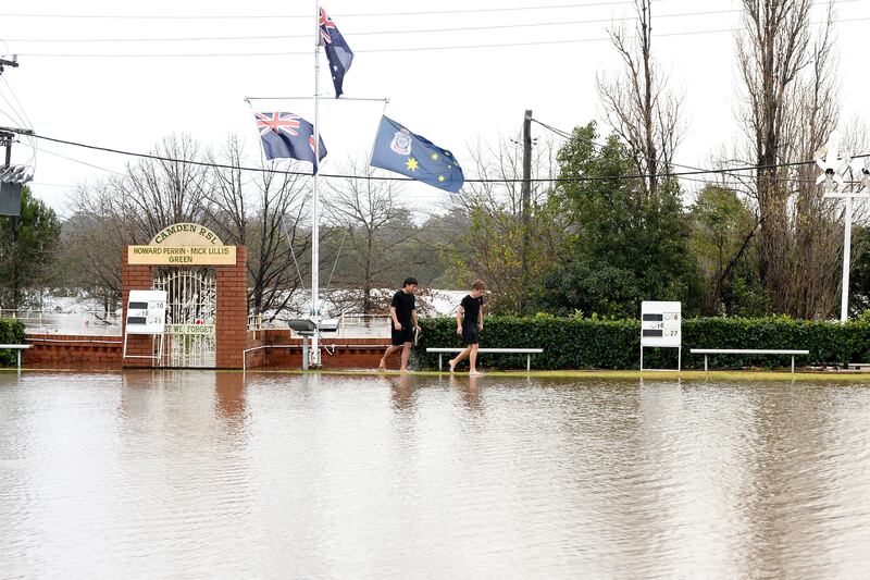 Residents make their way through flooded streets in Sydney's Camden suburb on Sunday. Photograph: Muhammad Farooq/AFP via Getty Images