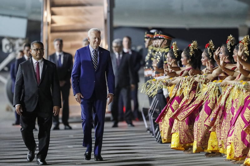 US president Joe Biden walks as Balinese dancers perform during his arrival for the G20 Summit at Ngurah Rai International airport in Bali on November 13th. Photograph: Made Nagi