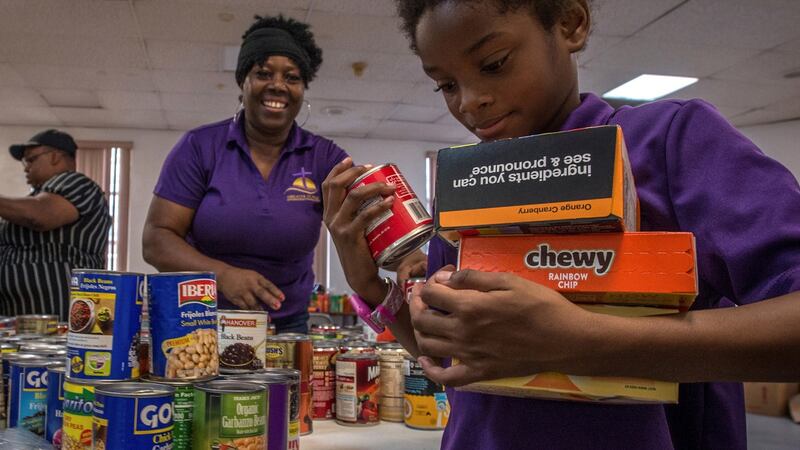 Eelen Ross and her daughter Karla Ross fill a box with goods in Greater St Paul, Coconut Grove, Miami, Florida on Tuesday. Photograph: EPA