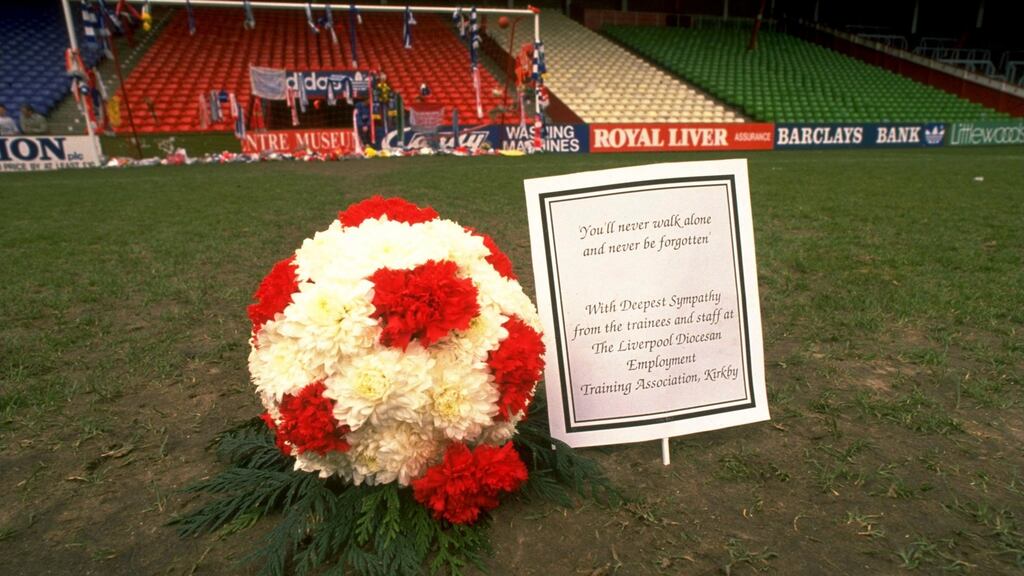A floral football lies on the pitch in tribute after the Hillsborough disaster in 1989. Photograph: Pascal Rondeau/Allsport