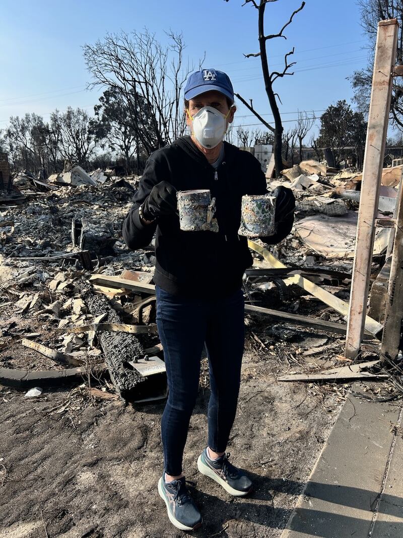 Sue Kohl with two Italian hand-painted mugs retrieved from the debris of her destroyed home.