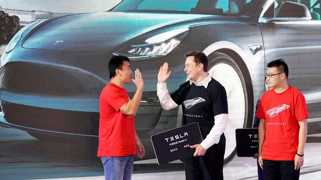 Tesla  CEO Elon Musk  with Tesla China-made Model 3 vehicle owners onstage during a delivery event at its Shanghai factory in China in January. Photograph: Reuters