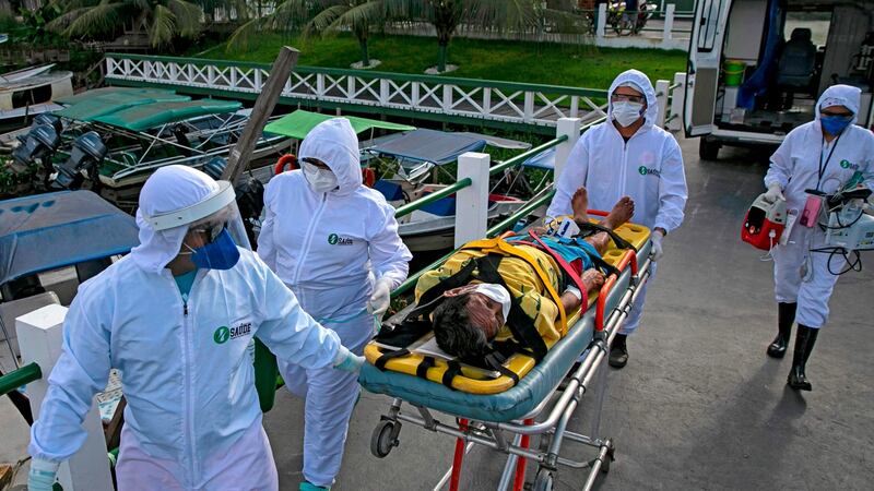 Emergency response personnel carry Covid-19 patient Eladio Lopes (79) to a hospital in Breves, on Marajo island, Para state, Brazil, on Monday. Photograph: Tarso Sarraf/AFP via Getty Images