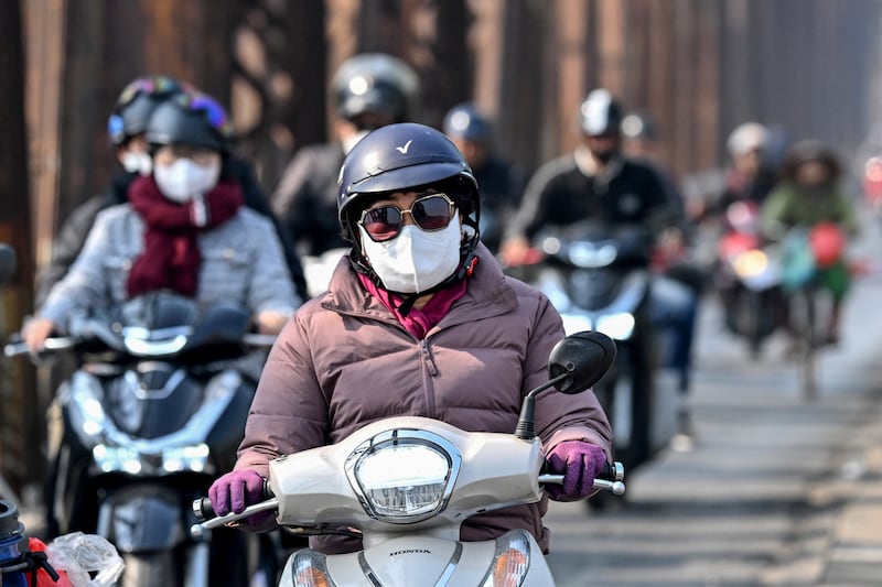 A motorist wearing a face mask rides a scooter on Long Bien Bridge amid heavy air pollution conditions in Hanoi on Friday. Photograph: Nhac Nguyen/AFP via Getty