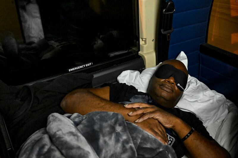 William Minor gets some rest on the Napaway sleeper coach. Photograph: Kenny Holston/The New York Times