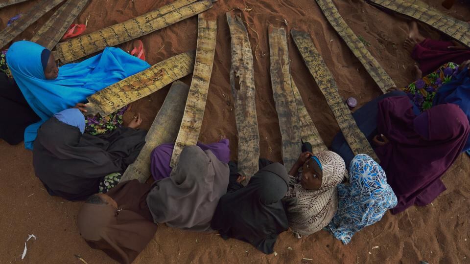 Displaced: Somali girls at morning madrasa, or Islamic school, use boards from the souk to practise Arabic calligraphy and learn verses from the Koran. Photograph: Tony Karumba/AFP/Getty