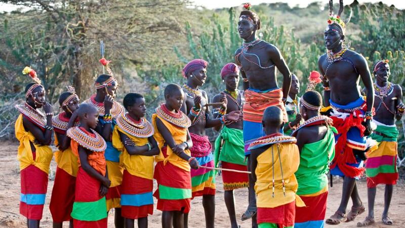 Young Masai girls look on as men exhibit their strength through the ritual dance Adumu. Photograph: Lar Boland