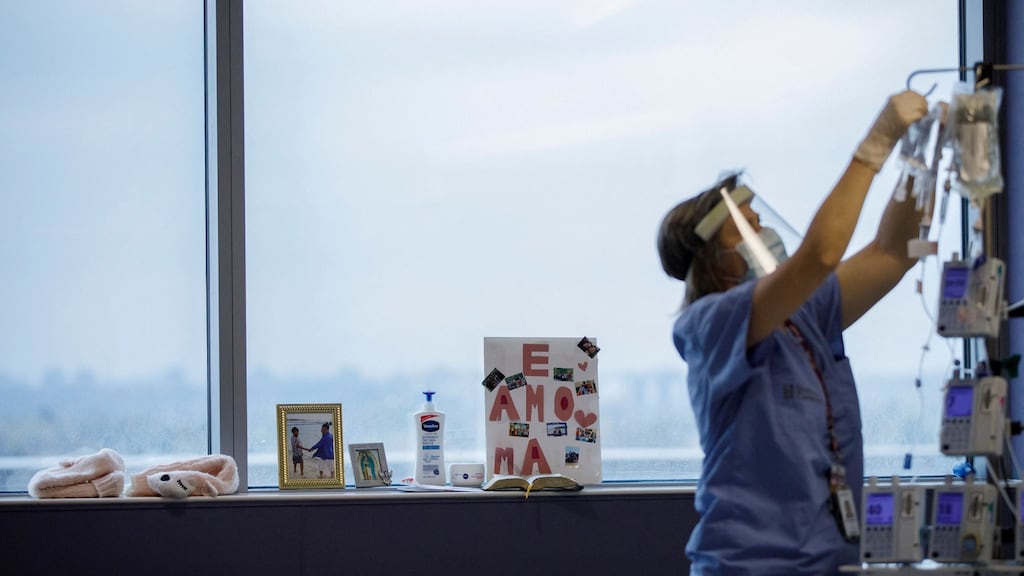 A Covid-19 patient’s personal belongings line the window as a nurse tends to them at the intensive care unit of Humber River Hospital in Toronto. Photograph:  Cole Burston/AFP via Getty Images