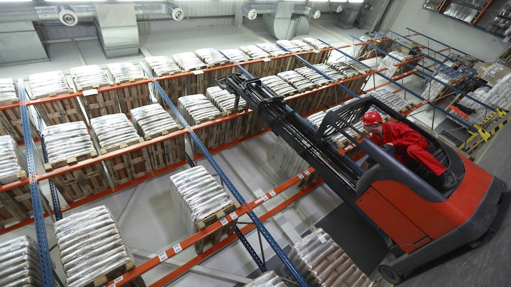 A worker lifting sacks with forklift