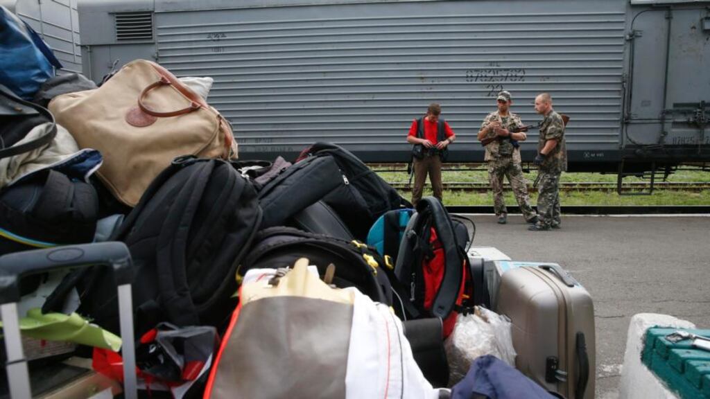 Armed pro-Russian separatists stand guard near the train transporting the remains of victims from the MH17 crash plane before its departure. Photograph: Maxim Zmeyev/Reuters