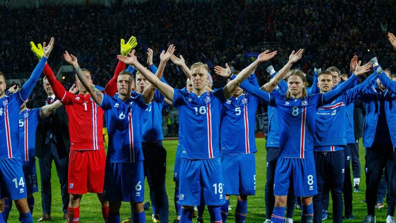 Iceland players do the now-famed ‘thunderclap routine’ with supporters after the victory over Kosovo in Reykjavik. Photograph: Birgir Thor Hardarson/EPA