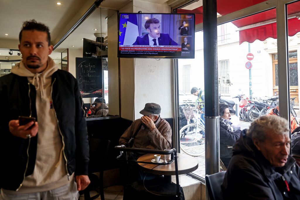 A television in a Paris bar shows the French President Emmanuel Macron's televised interview, in which he defended his proposed pension reforms. ( Photo: Shutterstock)