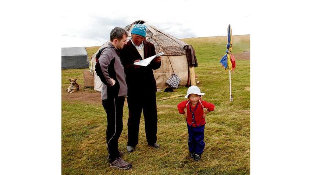 On the map: Diarmuid asks for directions during the Cunniffes' journey across Asia LONG AND WINDING ROAD Anna and Diarmuid Cunniffe on their bespoke bicycles