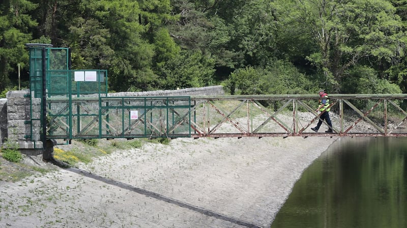 BRIDGE OVER TROUBLED WATER: Assistant inspector Ger Goodwin checks water levels in the upper lake of Bohernabreena reservoir, Dublin, as Irish Water warned it is "highly likely" a hosepipe ban will be imposed nationwide as certain water supplies fall to drought conditions. Photograph: Niall Carson/PA Wire