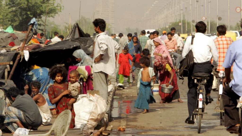 Slum dwellers live in makeshift huts by the roadside. Many governments in developing countries are more inclined to pursue economic growth than the goals of dignity and equality. Photograph: Reuters