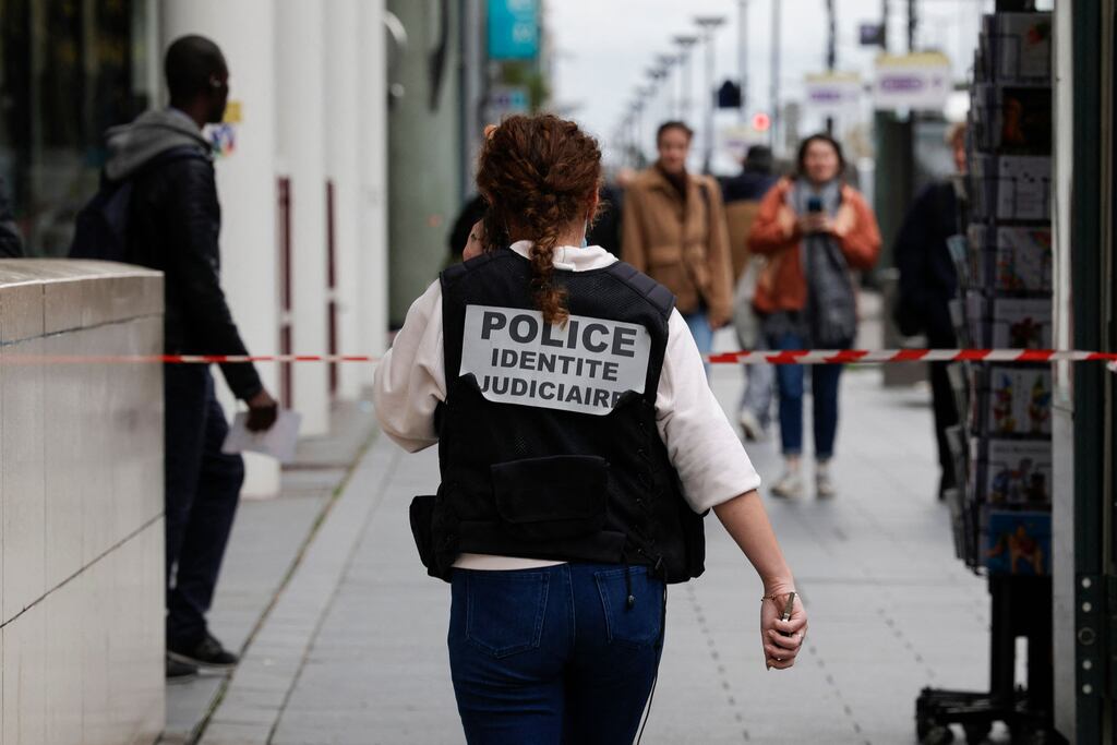 A French police officer walks from a metro station in Paris in Tuesday after a woman making threats shot and wounded by police. Photograph: Geoffroy Van der Hasselt/AFP via Getty Images