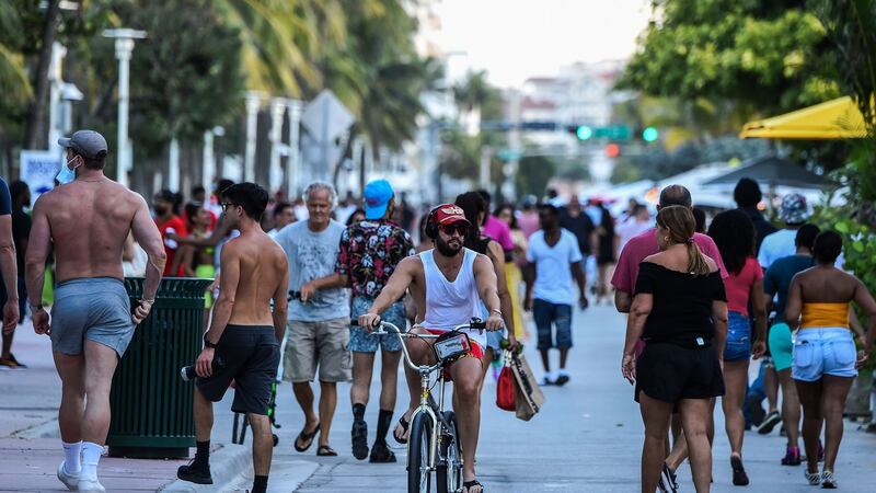 People cycling and walking along Ocean Drive in Miami Beach, Florida in late June. Photograph: Chandan Khanna/AFP/Getty