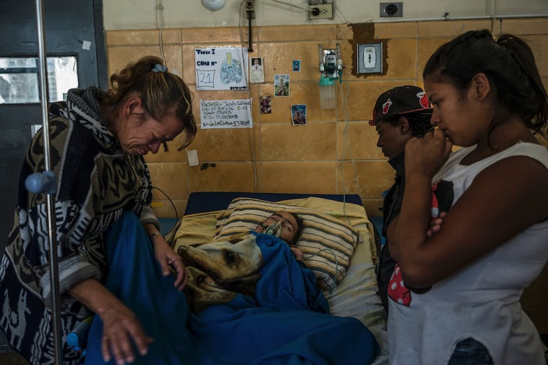 Jesús Contreras, (29), with family and friends in the tuberculosis ward of the Dr José Ignacio Baldó Hospital in Caracas last month.