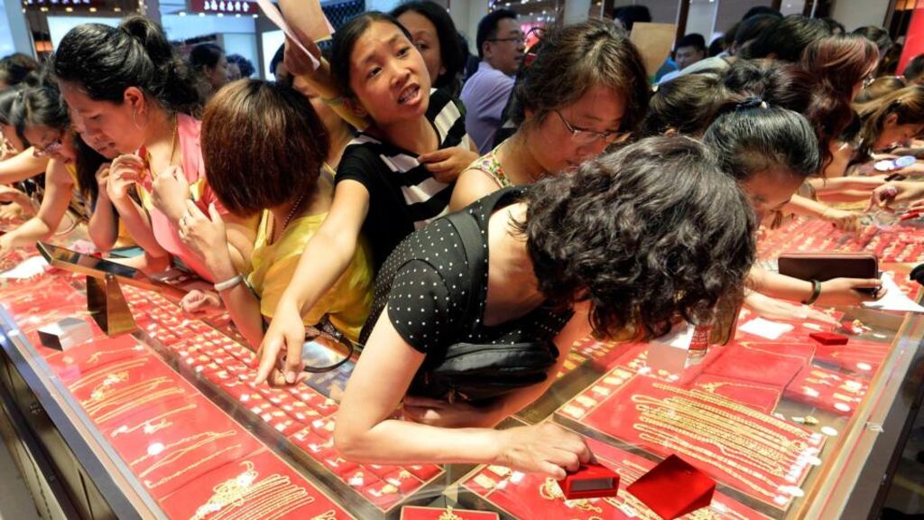 Sold on gold: buying accessories in Taiyuan, Shanxi province – the OECD predicts that a “small fiscal stimulus” will revive Chinese domestic demand and help push the country’s GDP growth from 7.7 per cent this year to 8.2 per cent in 2014. photograph: jon woo/reuters