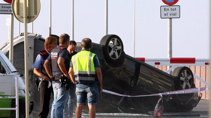 Members of the security forces look at a car used by attackers in the coastal city of Cambrils. Five alleged terrorists, who apparently wore bomb belts, were shot dead by security forces as they were ran away in Cambrils this morning. Photograph: EPA