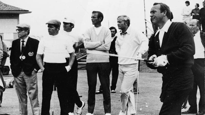 Arnold Palmer drives off of the first tee during the 1970 British Open at St Andrews while Jack Nicklaus and Gary Player look on. Photograph: Express Newspapers/Getty Images