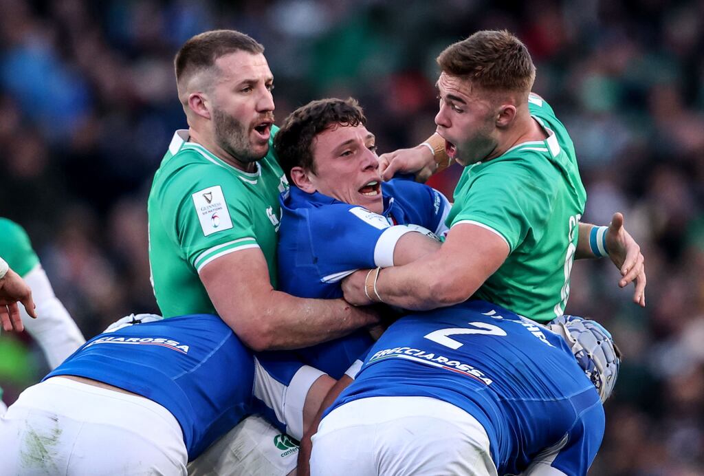 Ireland’s Stuart McCloskey and Jack Crowley holding up Italy's Paolo Garbisi in their Six Nations game at the Aviva Stadium on February 11th. Photograph: Dan Sheridan/IInpho