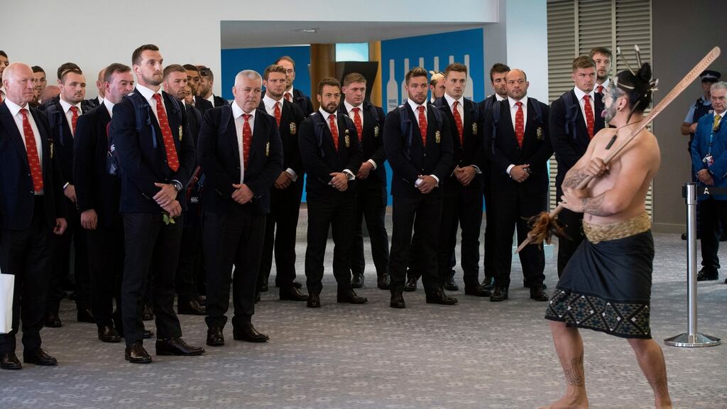 The British and Irish Lions squad watch as a maori warrior leads a haka on their arrival at Auckland. Photograph: NZ Herald/PA