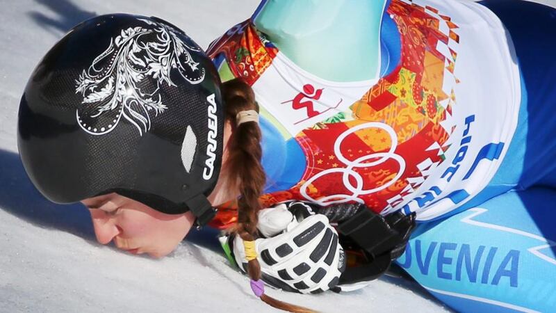 Tina Maze of Slovenia kisses the snow in the finish area after her run in the women’s downhill race at the Rosa Khutor Alpine Centre, which saw her share the gold medal with Dominique Gisin of Switzerland. Photograph: Fredrik Von Erichsen/EPA