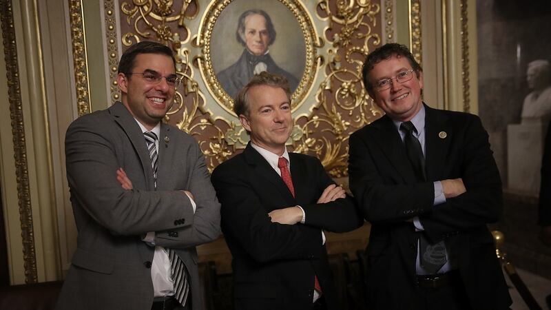 Senator Rand Paul (centre) takes a brief break from the floor of the US Senate to pose for a photo with Rep. Justin Amash (left) and Rep. Thomas Massie (right). Photograph: Gretty