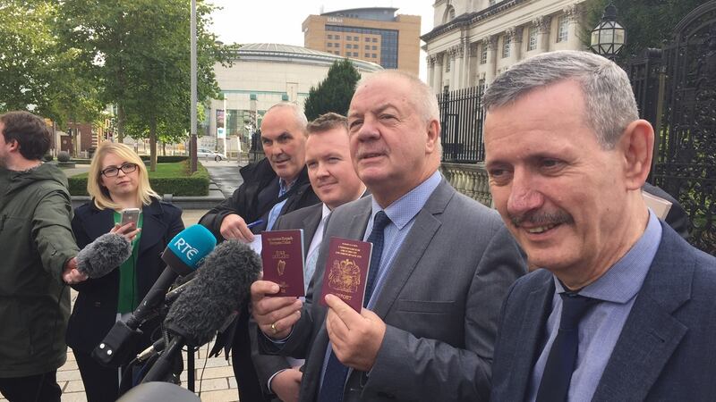 Victims’ campaigner Raymond McCord - who was behind one of two applications challenging the outcome of the Brexit referendum - displays the Irish passport he received on Thursday, together with his British passport, outside the High Court in Belfast.