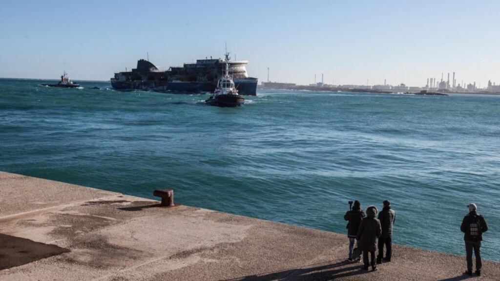 People watch the stricken ‘Norman Atlantic’ ferry, pulled by tug boats, arriving at Brindisi natural habour in Brindisi, Italy. Photograph: Maria Novella de Luca/EPA