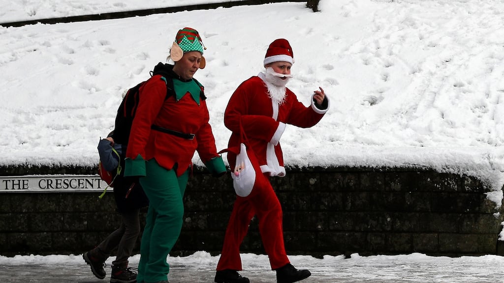No Christmas Day for Ireland. Women in festive fancy dress walk after snow fall this month in Buxton, Britain. Photograph: Darren Staples/Reuters